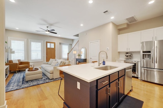 2520 Bluebonnet Ln Unit 41, Austin, TX 78704 - kitchen featuring stainless steel appliances, a sink, light wood-type flooring, light countertops, and ceiling fan