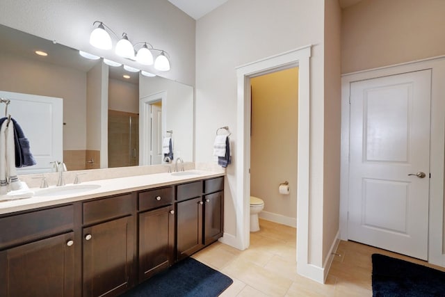 2520 Bluebonnet Ln Unit 41, Austin, TX 78704 - bathroom featuring a shower stall, double vanity, toilet, tile patterned flooring, and baseboards