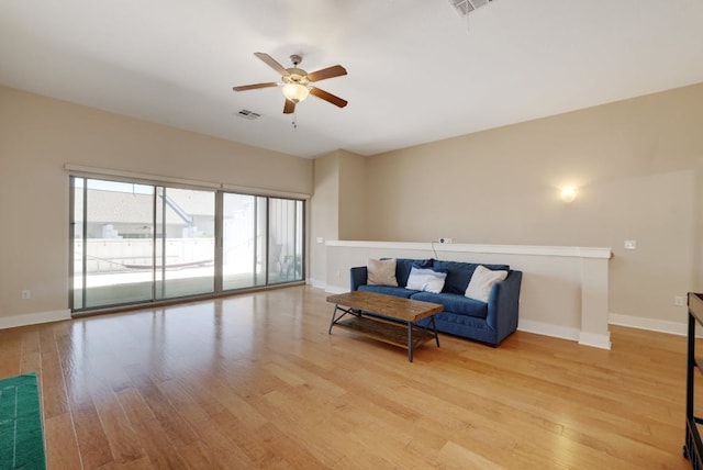 2520 Bluebonnet Ln Unit 41, Austin, TX 78704 - living area featuring light wood finished floors, ceiling fan, and baseboards