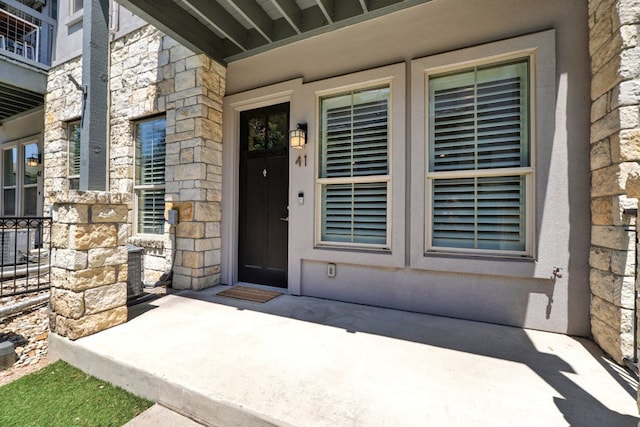 2520 Bluebonnet Ln Unit 41, Austin, TX 78704 - doorway to property with stone siding and a patio area