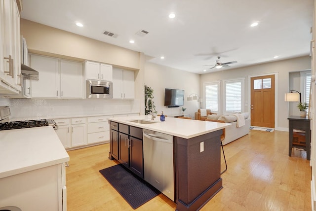 2520 Bluebonnet Ln Unit 41, Austin, TX 78704 - kitchen featuring appliances with stainless steel finishes, a sink, open floor plan, light countertops, and a ceiling fan