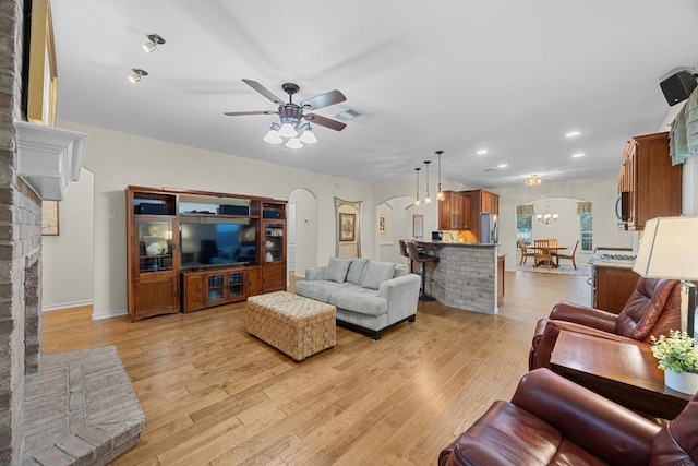 2518 Nightshade Dr, Cedar Park, TX 78613 - living area featuring arched walkways, light wood finished floors, recessed lighting, a ceiling fan, and a chandelier
