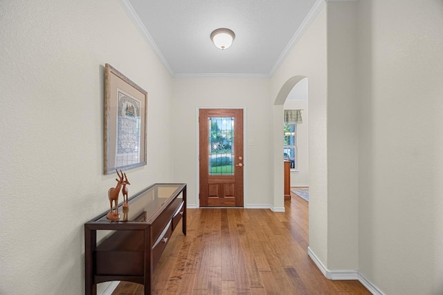 2518 Nightshade Dr, Cedar Park, TX 78613 - foyer entrance featuring arched walkways, wood-type flooring, and crown molding
