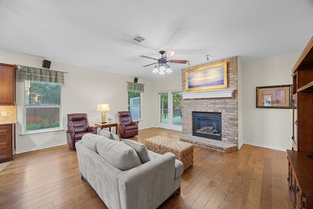 2518 Nightshade Dr, Cedar Park, TX 78613 - living area with ceiling fan, a brick fireplace, and wood finished floors