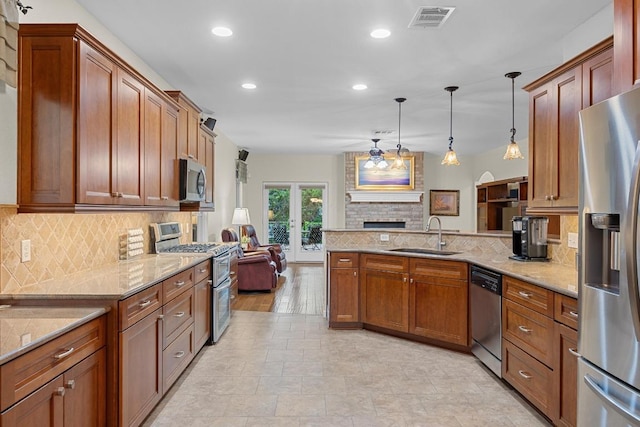 2518 Nightshade Dr, Cedar Park, TX 78613 - kitchen with appliances with stainless steel finishes, a sink, open floor plan, a peninsula, and recessed lighting