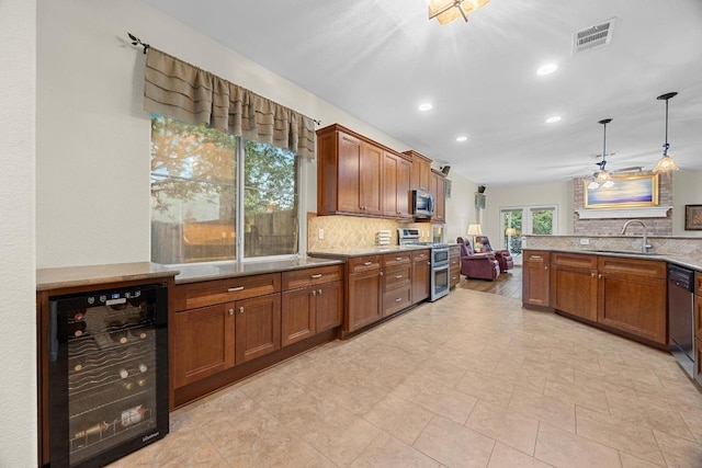 2518 Nightshade Dr, Cedar Park, TX 78613 - kitchen featuring wine cooler, appliances with stainless steel finishes, tasteful backsplash, a sink, and brown cabinets