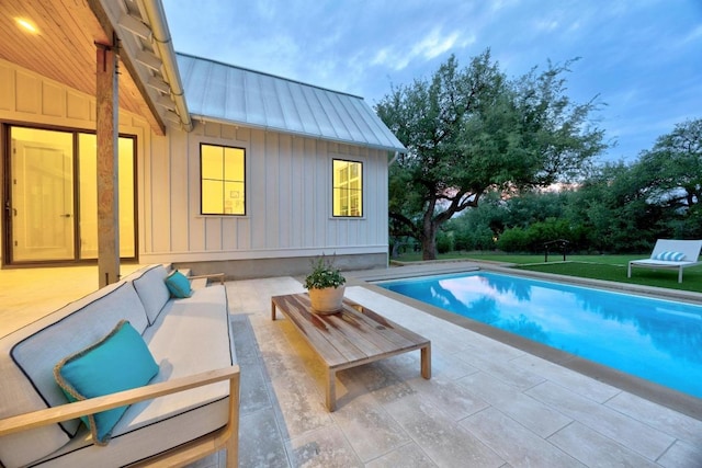 swimming pool with a patio area and outdoor lounge area