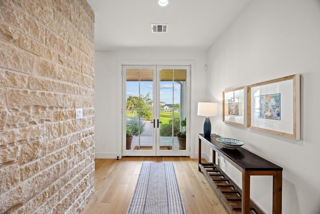 entryway featuring hardwood / wood-style floors and french doors