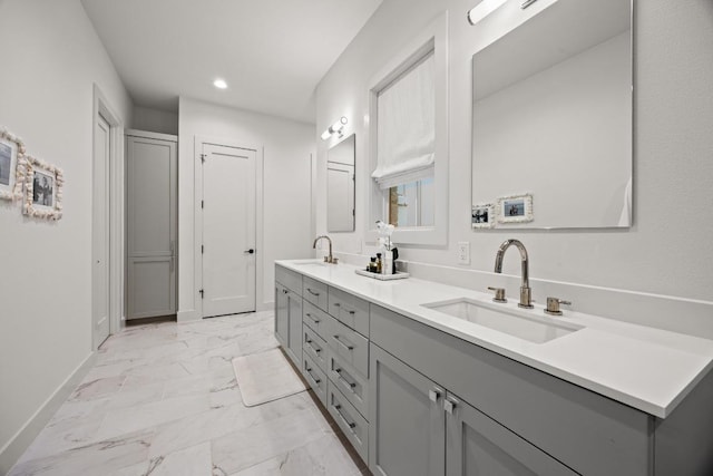 full bathroom with marble finish flooring, baseboards, recessed lighting, and double vanity