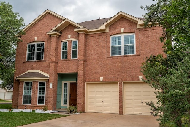 8610 Axis Dr, Austin, TX 78749 - view of front of house featuring concrete driveway, brick siding, and an attached garage