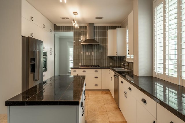 8610 Axis Dr, Austin, TX 78749 - kitchen featuring stainless steel appliances, wall chimney exhaust hood, crown molding, healthy amount of natural light, and decorative backsplash