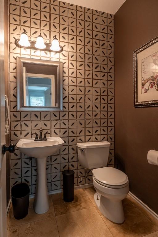 8610 Axis Dr, Austin, TX 78749 - half bathroom with toilet and tile patterned flooring