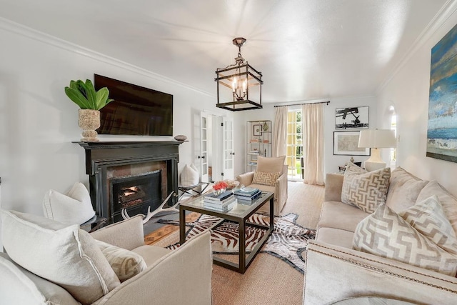 carpeted living room with crown molding, a fireplace, and a chandelier