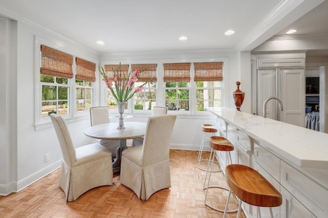 dining room featuring ornamental molding, baseboards, and recessed lighting