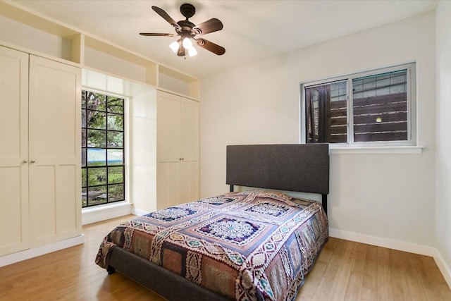 3508 Winfield Cv, Austin, TX 78704 - bedroom featuring light wood-type flooring, baseboards, and a ceiling fan