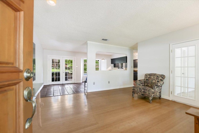 3508 Winfield Cv, Austin, TX 78704 - living area with a textured ceiling, wood finished floors, french doors, and baseboards