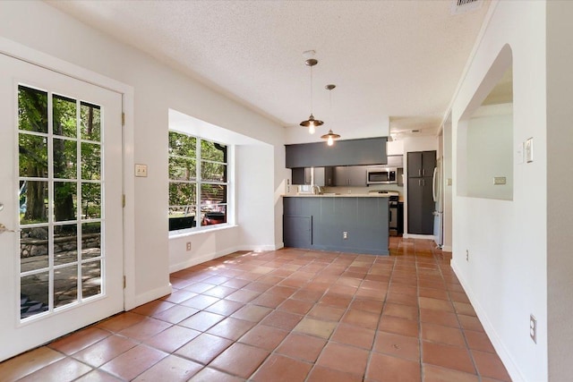 3508 Winfield Cv, Austin, TX 78704 - kitchen featuring stainless steel microwave, range with electric cooktop, a peninsula, light countertops, and tile patterned floors