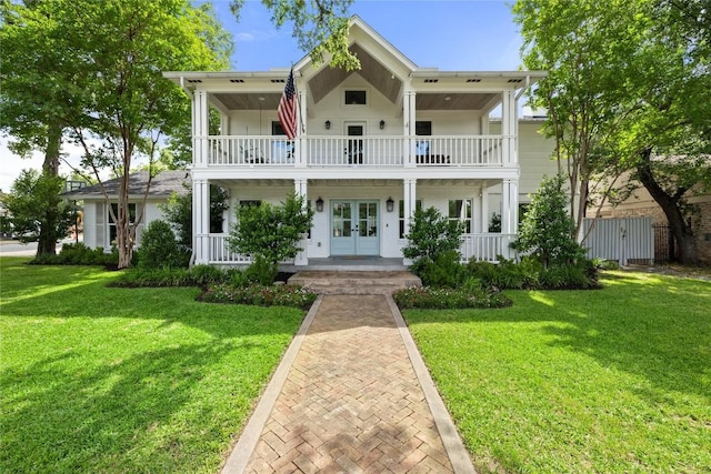 3115 Thousand Oaks Dr, Austin, TX 78746 - view of front of home featuring french doors, a balcony, a porch, and a front yard