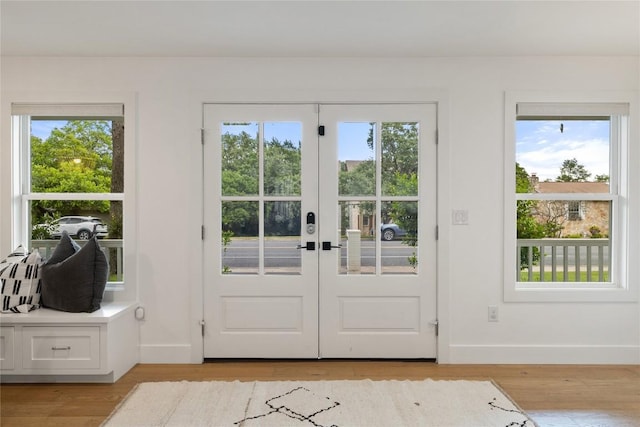 3115 Thousand Oaks Dr, Austin, TX 78746 - doorway featuring baseboards, healthy amount of natural light, light wood-type flooring, and french doors