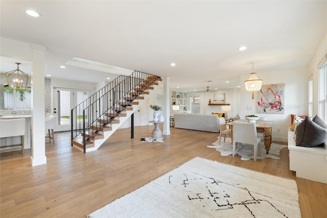 3115 Thousand Oaks Dr, Austin, TX 78746 - living room with stairs, wood finished floors, a chandelier, recessed lighting, and baseboards