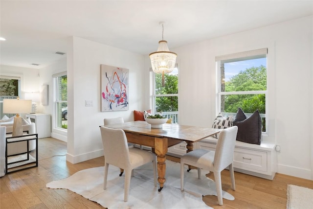 3115 Thousand Oaks Dr, Austin, TX 78746 - dining room with light wood-type flooring, baseboards, and a chandelier