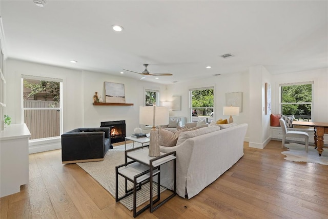 3115 Thousand Oaks Dr, Austin, TX 78746 - living area with a glass covered fireplace, light wood-type flooring, a ceiling fan, recessed lighting, and baseboards