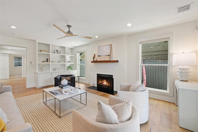 3115 Thousand Oaks Dr, Austin, TX 78746 - living room with a fireplace with flush hearth, light wood-type flooring, a ceiling fan, recessed lighting, and baseboards