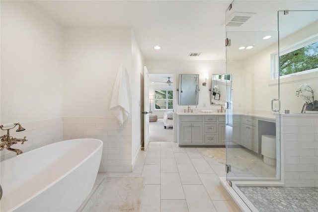 3115 Thousand Oaks Dr, Austin, TX 78746 - bathroom with vanity, a soaking tub, a stall shower, recessed lighting, and tile patterned floors
