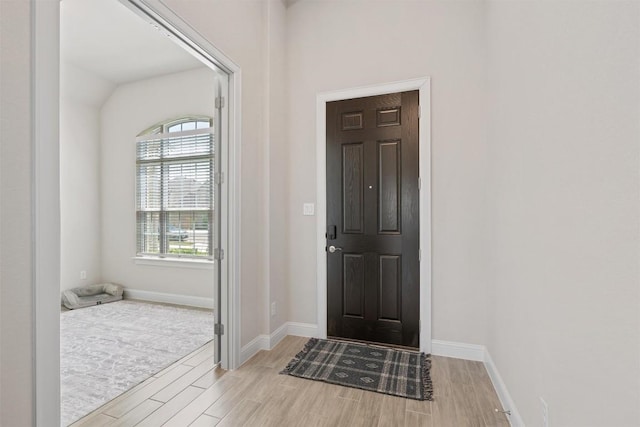 entrance foyer with light wood-style floors and baseboards