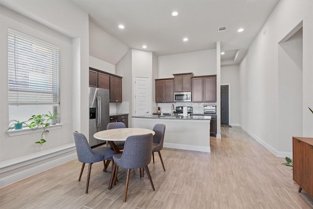 dining space featuring light wood-style flooring, baseboards, and recessed lighting