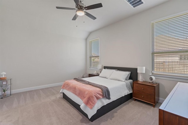 bedroom with light carpet, baseboards, vaulted ceiling, and a ceiling fan