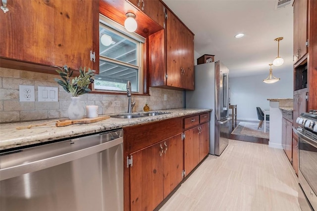 8313 Burrell Dr, Austin, TX 78757 - kitchen featuring appliances with stainless steel finishes, a sink, tasteful backsplash, brown cabinetry, and recessed lighting