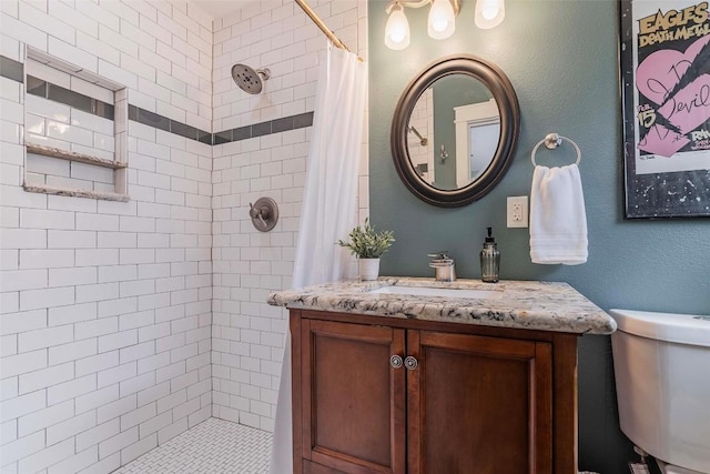 8313 Burrell Dr, Austin, TX 78757 - bathroom featuring a tile shower, vanity, and toilet
