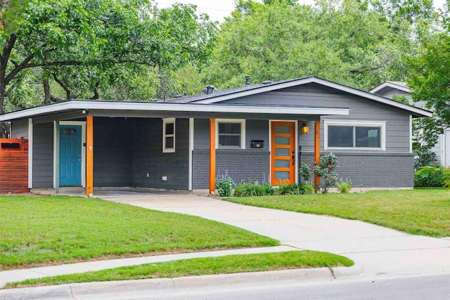 8313 Burrell Dr, Austin, TX 78757 - view of front of property with a front yard, brick siding, driveway, and an attached carport