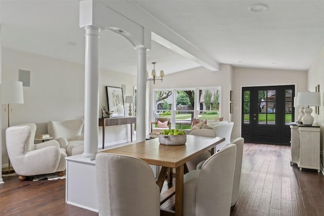 1513 Westover Rd, Austin, TX 78703 - dining room featuring dark wood-style floors, ornate columns, and a chandelier