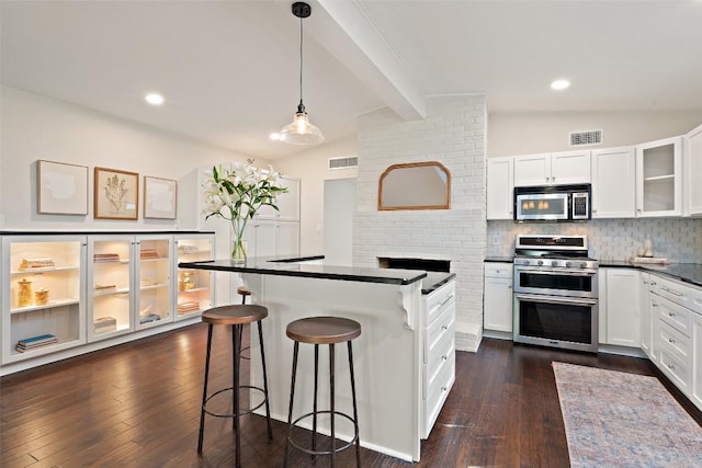 1513 Westover Rd, Austin, TX 78703 - kitchen with stainless steel appliances, dark countertops, white cabinetry, and dark wood-type flooring