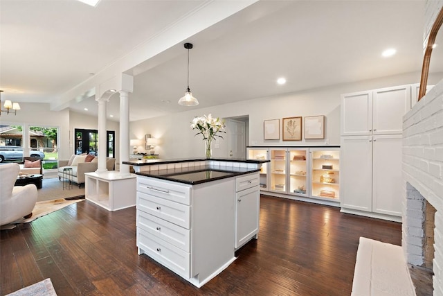 1513 Westover Rd, Austin, TX 78703 - kitchen with dark countertops, dark wood-style floors, decorative light fixtures, recessed lighting, and white cabinets
