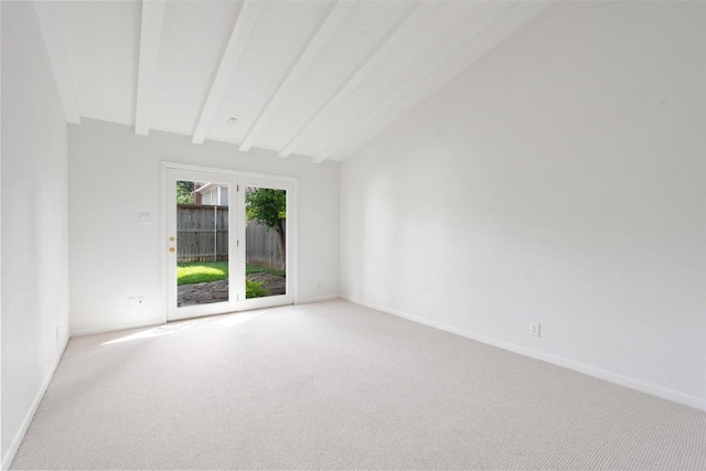 spare room featuring light colored carpet and baseboards