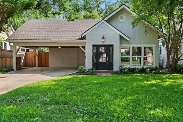 view of front of home with brick siding, roof with shingles, concrete driveway, and an attached carport