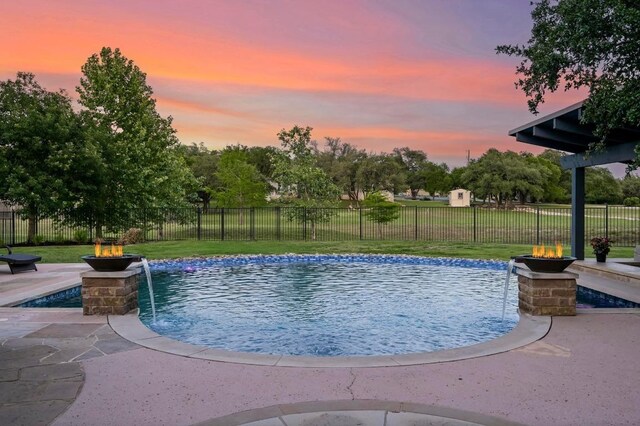 209 Ridge View Dr, Georgetown, TX 78628 - pool at dusk with an outdoor fire pit and a patio
