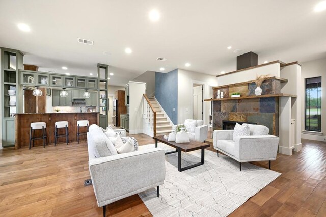 209 Ridge View Dr, Georgetown, TX 78628 - living room with light wood-style floors, recessed lighting, a fireplace, baseboards, and stairway