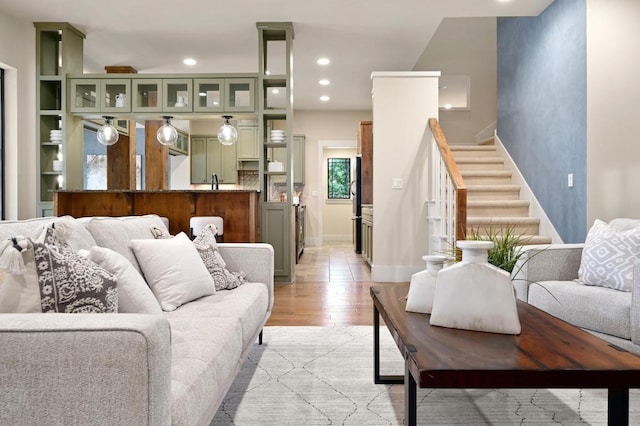 209 Ridge View Dr, Georgetown, TX 78628 - living room featuring light wood finished floors, stairway, recessed lighting, and baseboards