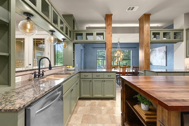 209 Ridge View Dr, Georgetown, TX 78628 - kitchen with stainless steel dishwasher, a sink, green cabinetry, and butcher block countertops