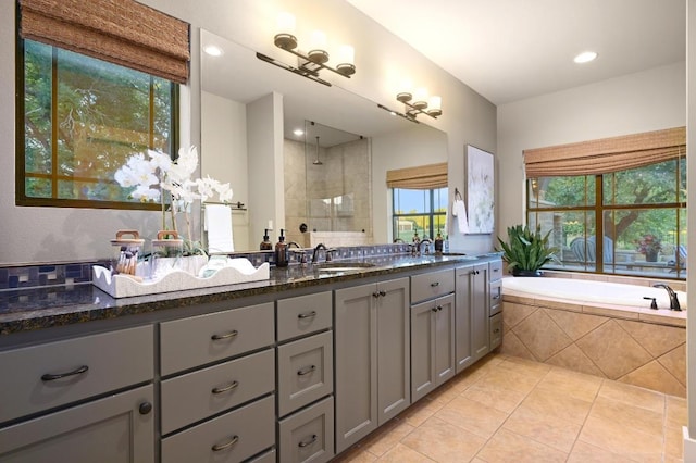209 Ridge View Dr, Georgetown, TX 78628 - bathroom featuring tile patterned floors, double vanity, tiled shower, and a garden tub