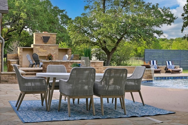 209 Ridge View Dr, Georgetown, TX 78628 - view of patio featuring an outdoor fireplace, outdoor dining area, and fence