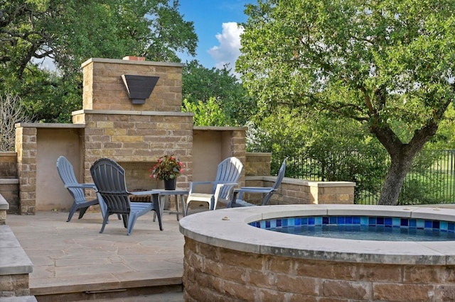 209 Ridge View Dr, Georgetown, TX 78628 - view of patio featuring an outdoor brick fireplace and an in-ground hot tub