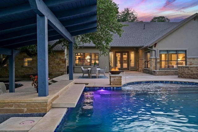 209 Ridge View Dr, Georgetown, TX 78628 - pool at dusk with french doors, a patio, and an outdoor pool