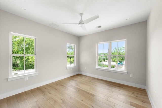 empty room with baseboards, light wood-style floors, and ceiling fan