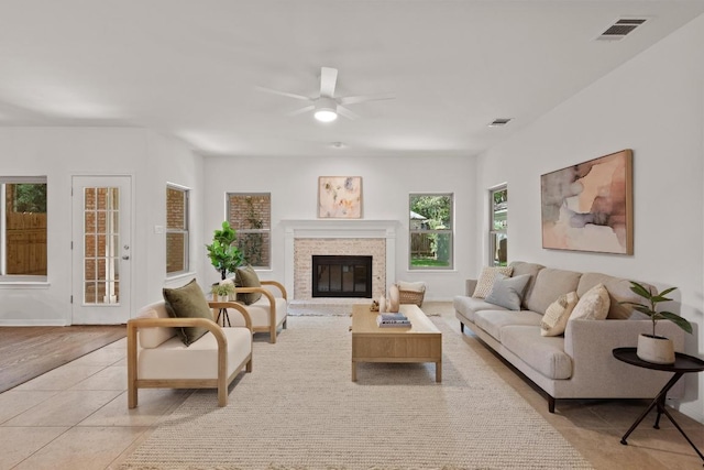 6304 John Chisum Ln, Austin, TX 78749 - living area with ceiling fan, light tile patterned floors, and a glass covered fireplace
