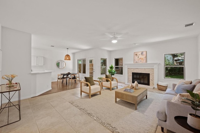 6304 John Chisum Ln, Austin, TX 78749 - living room featuring a ceiling fan, light tile patterned flooring, and a glass covered fireplace